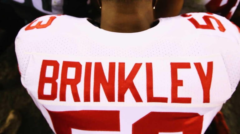 Jasper Brinkley #53 of the New York Giants prays with...