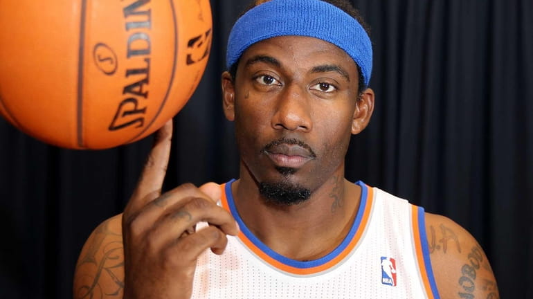 Amar'e Stoudemire spins a basketball during Knicks' media day in...