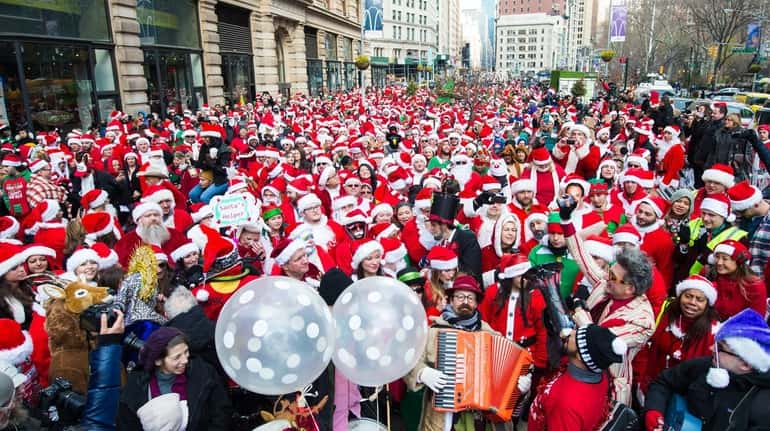 People dressed as Santas gather for the start of SantaCon...