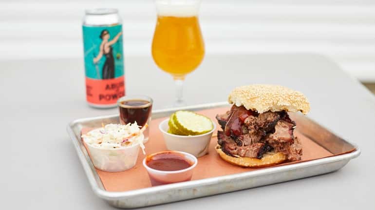The smoked brisket sandwich served with coleslaw, pickles and house...