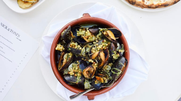 Wood roasted mussels with fregola verde, white wine, garlic, and...