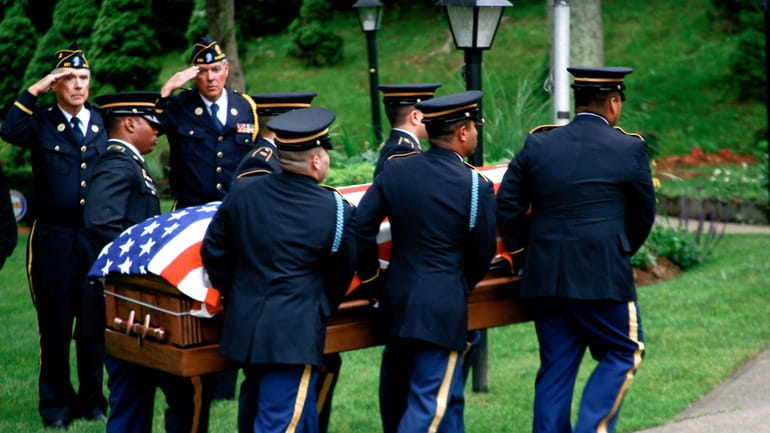 Army Lt. Joseph Theinert's coffin is carried at Our Lady...
