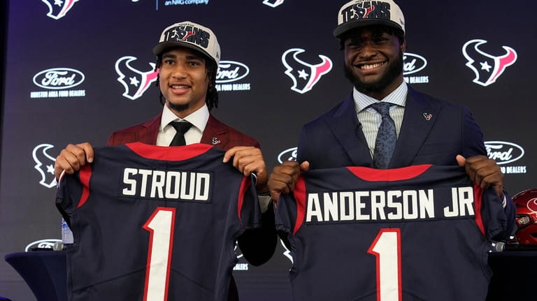 Houston Texans first round draft picks quarterback C.J. Stroud, left,...