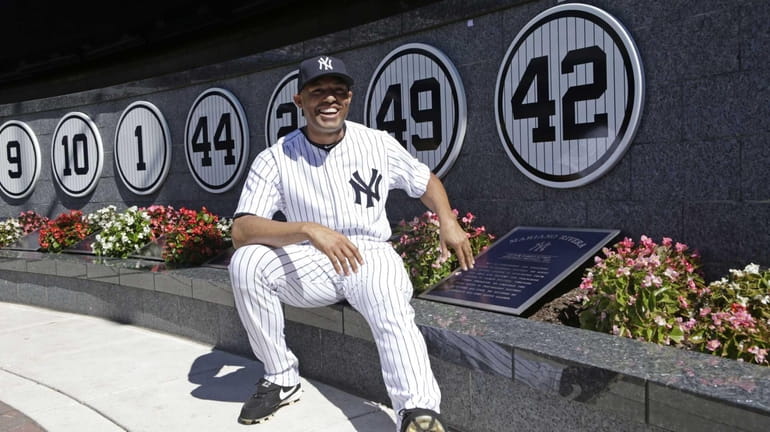 Yankees closer Mariano Rivera poses with a plaque showing his...
