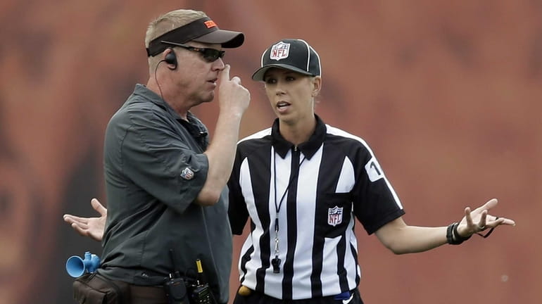 Referee trainee Sarah Thomas, right, talks to Cleveland Browns equipment...