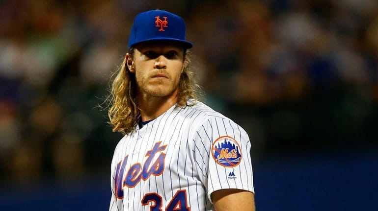 Noah Syndergaard #34 of the New York Mets looks on...