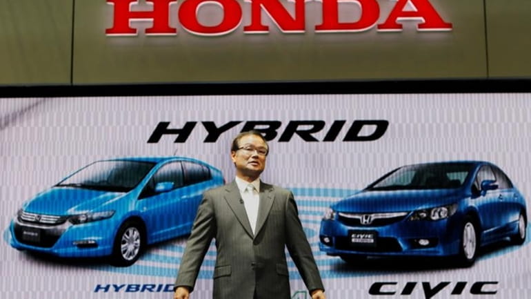 Honda Motor Co. president Takanobu Ito introduces hybrid vehicles Insight...