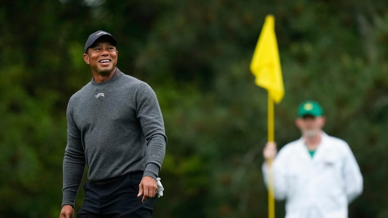 Tiger Woods smiles on on the fifth green during a...