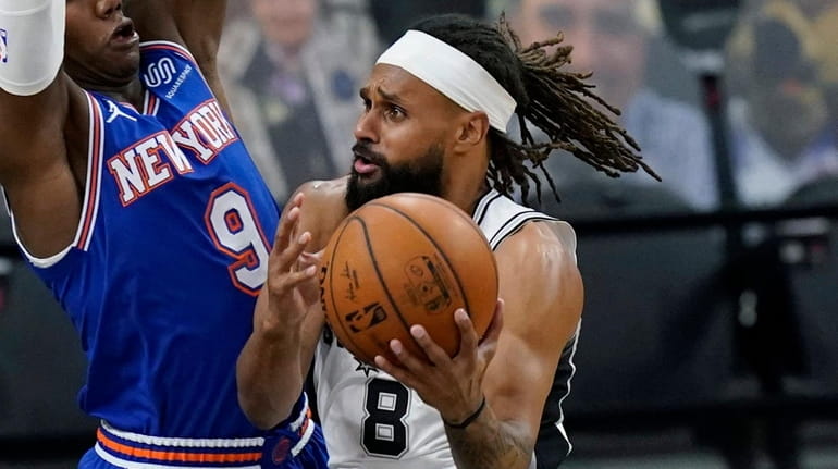 Spurs guard Patty Mills drives to the basket against Knicks...