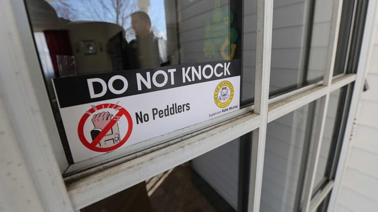 A "Do Not Knock" door decal is pictured on the...
