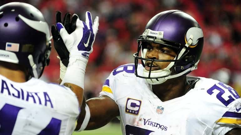 Adrian Peterson of the Minnesota Vikings celebrates a touchdown during...