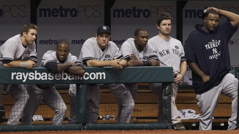 Members of the New York Yankees watch the ninth inning...