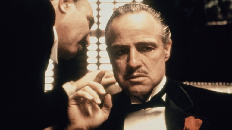 Marlon Brando, right, as Don Corleone, in a scene from...