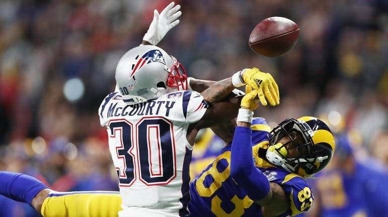 Jason McCourty #30 of the New England Patriots defends a...