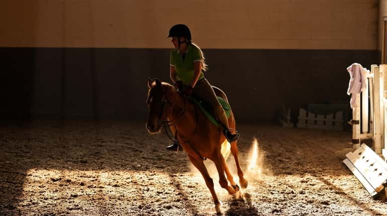 Chrissy Quinn, of Hicksville, rides her quarter pony Bella while...