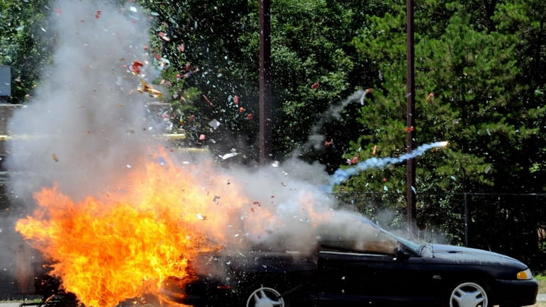 Fireworks blow up in the trunk of car during a...
