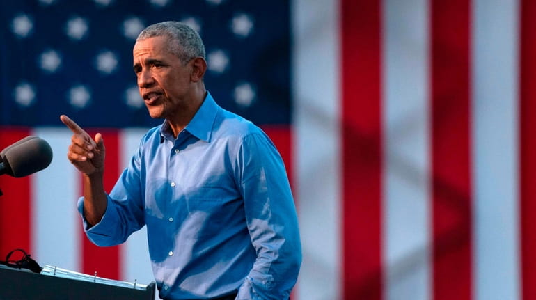 Former President Barack Obama addresses Biden-Harris supporters during a drive-in...