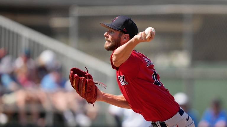 Boston Red Sox starting pitcher Chris Sale throws in the...