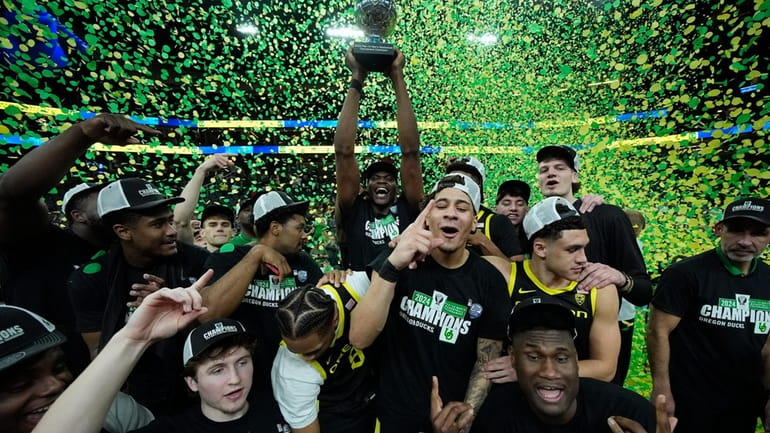 Oregon players celebrate after defeating Colorado in an NCAA college...