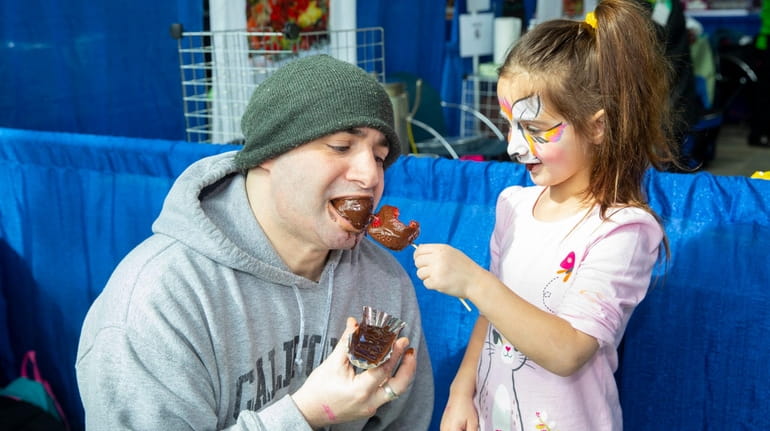 Hannah Potenti, 6, of Hicksville, feeds her father, Chris Potenti...