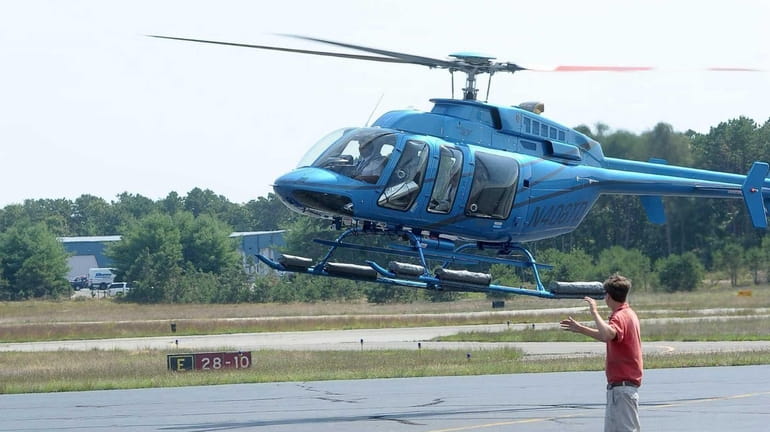 A helicopter lands at East Hampton Airport on Aug. 22,...