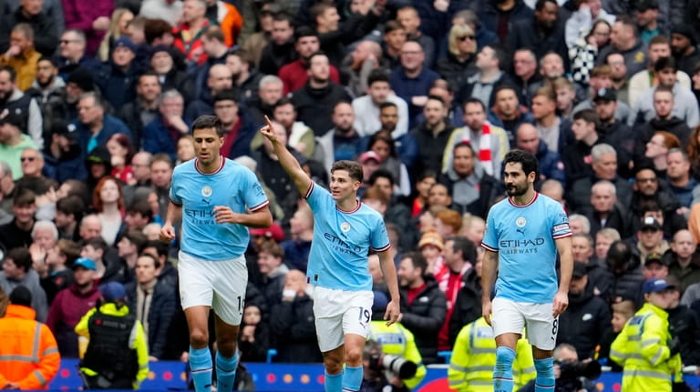 Manchester City's Julian Alvarez, center, celebrates with teammates after scoring...