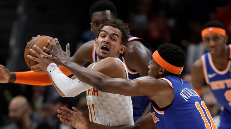 Atlanta Hawks guard Trae Young is covered by Knicks guard...