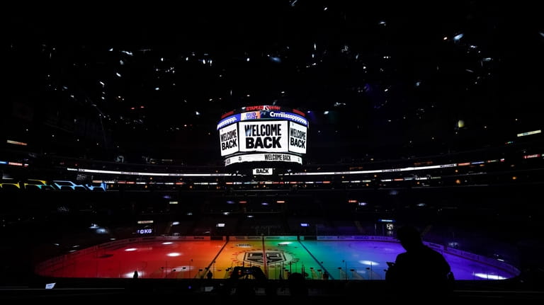 FILE - The ice is lit in rainbow light for...