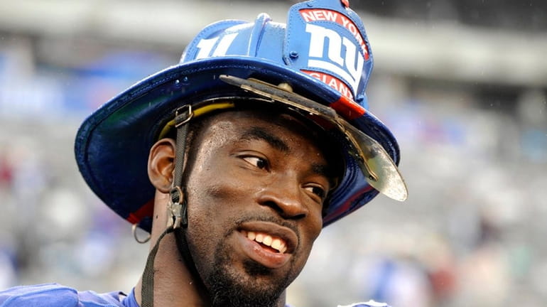 Giants defensive captain Justin Tuck wore a fire helmet symbolic...