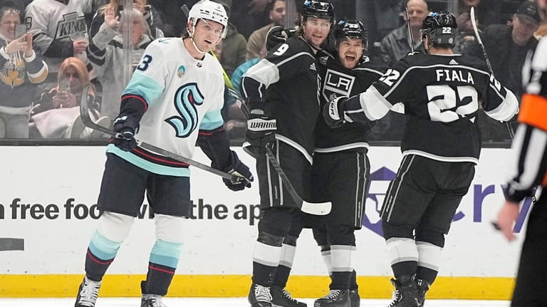 Los Angeles Kings right wing Adrian Kempe, second from left,...