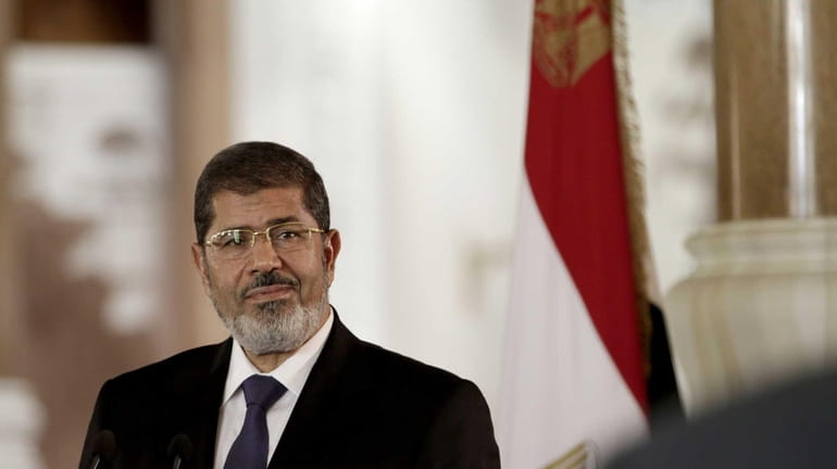 Egyptian President Mohammed Morsi speaks to reporters during a news...