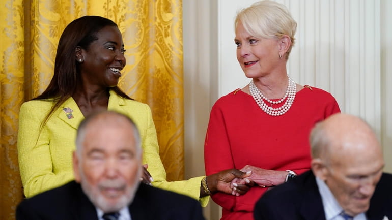 LI’s Sandra Lindsay, left, comforts Cindy McCain when President Joe...