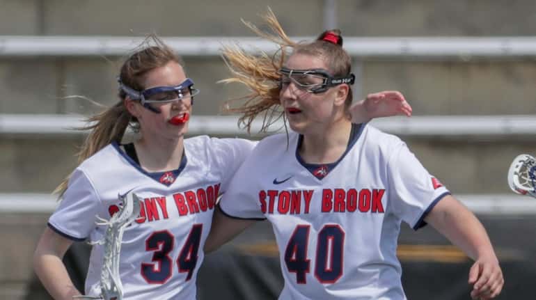 Stony Brook's Sara Moeller is congratulated by teammate Mikayla Dwyer after scoring...