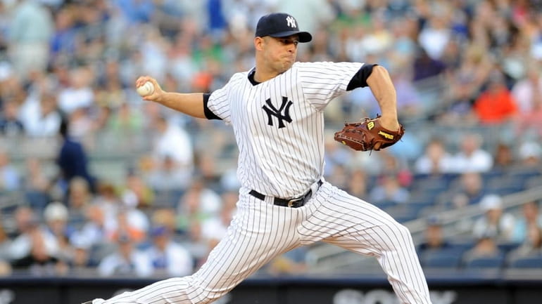 New York Yankees starting pitcher Javier Vazquez #31 throws in...