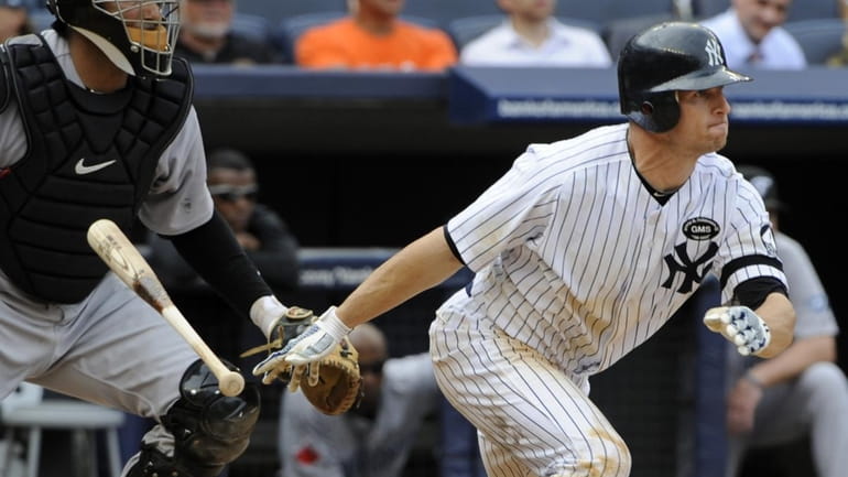 New York Yankees' Brett Gardner hits a triple during the...