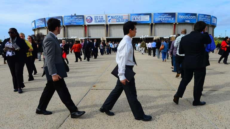 Job seekers gather Oct. 7, 2014, at Nassau Coliseum to...