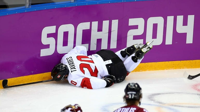 John Tavares of Canada dives into the boards during the...