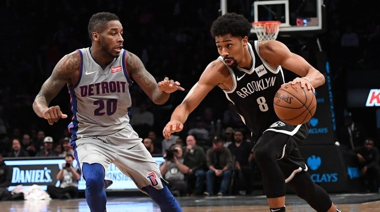Nets guard Spencer Dinwiddie drives on Pistons' Dwight Buycks at...