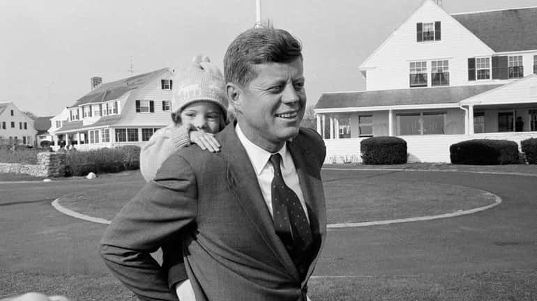 Caroline Kennedy gets a piggy-back ride from her father, Sen....