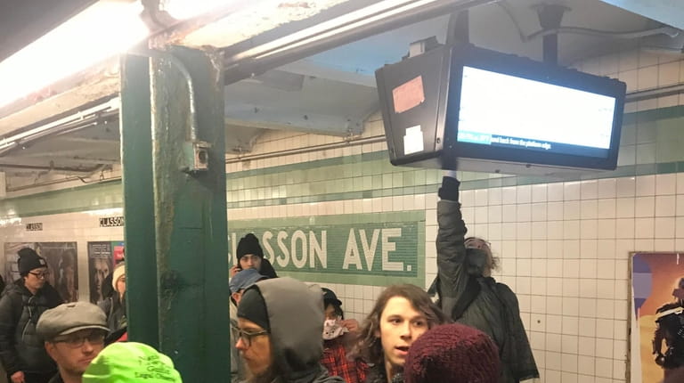 A demonstrator Friday night at the Classon Avenue G train subway...