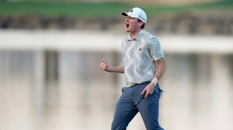 Nick Dunlap reacts after making his putt on the 18th...