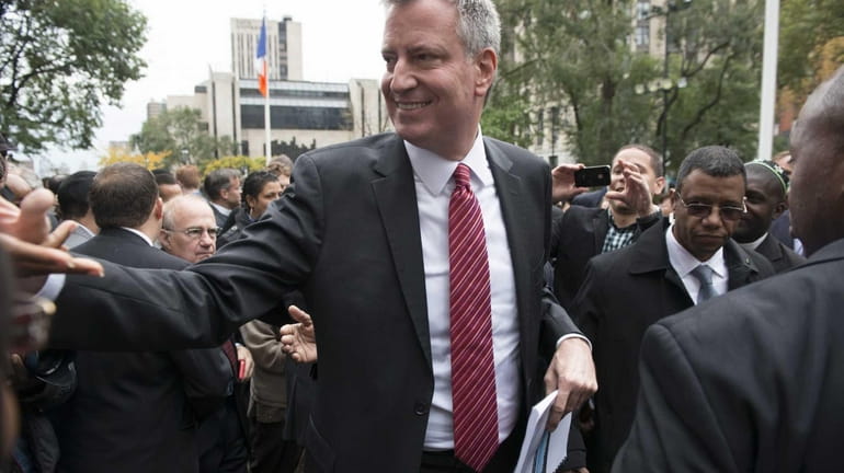Democratic mayoral candidate Bill de Blasio greets supporters after a...