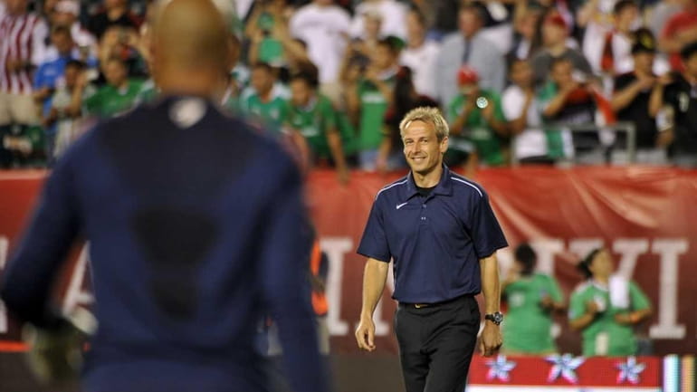 Team USA coach Jurgen Klinsmann is cheered as he walks...
