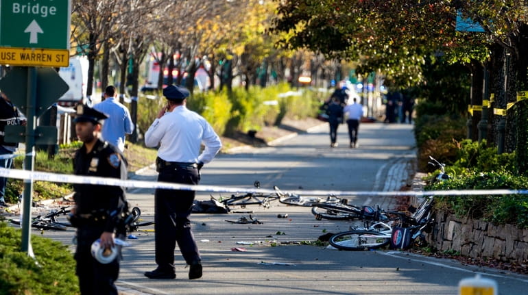 Bicycles and debris lay on a bike path after an...