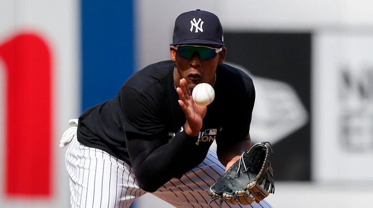 Miguel Andujar of the Yankees warms up in the field...