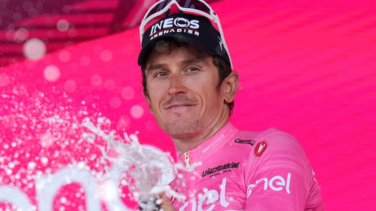 Geraint Thomas celebrates retaining the pink jersey of leader of...