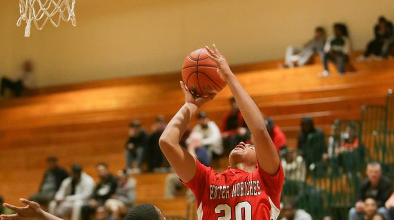 Center Moriches Jaden Kealey (20) takes a shot while being...