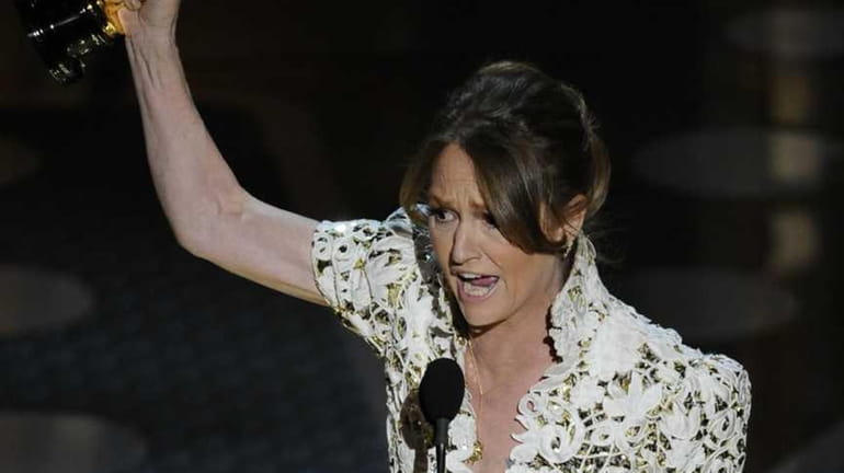 Melissa Leo accepts the Oscar for best actress in a...