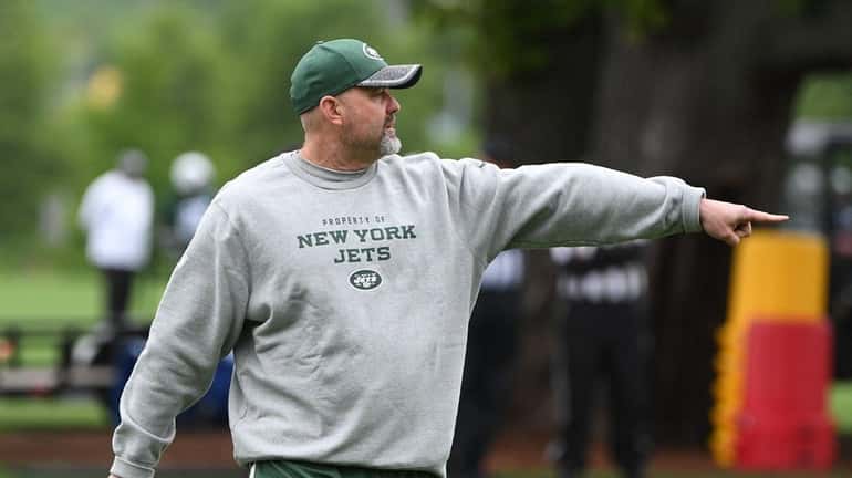 Jets offensive coordinator John Morton directs players during OTAs at...