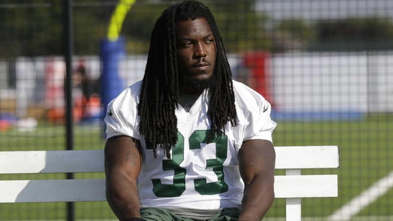 New York Jets' running back Chris Ivory uses a stretching...